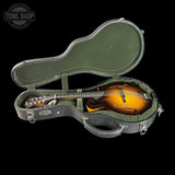 Mandolin in a green case with 'Tone Shop' logo in the corner.