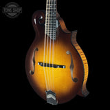Wooden mandolin with a dark brown finish on a black background, featuring the Tone Shop logo.