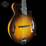 Wooden mandolin with a dark background, featuring the Tone Shop logo.