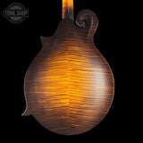 Close-up of a wooden guitar body with a visible brand logo in the corner.