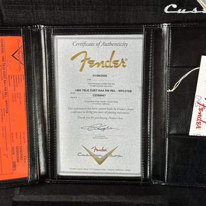 Fender certificate of authenticity in a black leather case with visible branding.