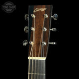 Close-up of a guitar headstock with six tuning pegs, six strings, and a dark brown wood finish. The brand name 'Colings' is printed in gold on the headstock.