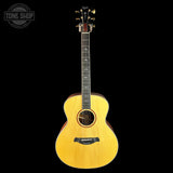 Acoustic guitar with a visible brand logo on a black background