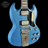 Blue electric guitar with Gibson logo on a black background