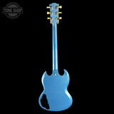 Blue electric guitar with a 'Tone Shop' logo in the corner