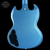 Blue electric guitar body with 'Tone Shop' logo in the corner