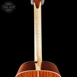 Close-up of a guitar's back and neck with 'Tone Shop' logo.