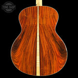 Wooden guitar back with a visible brand logo in the corner