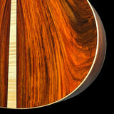 Close-up of a wooden guitar soundboard with a visible grain pattern.