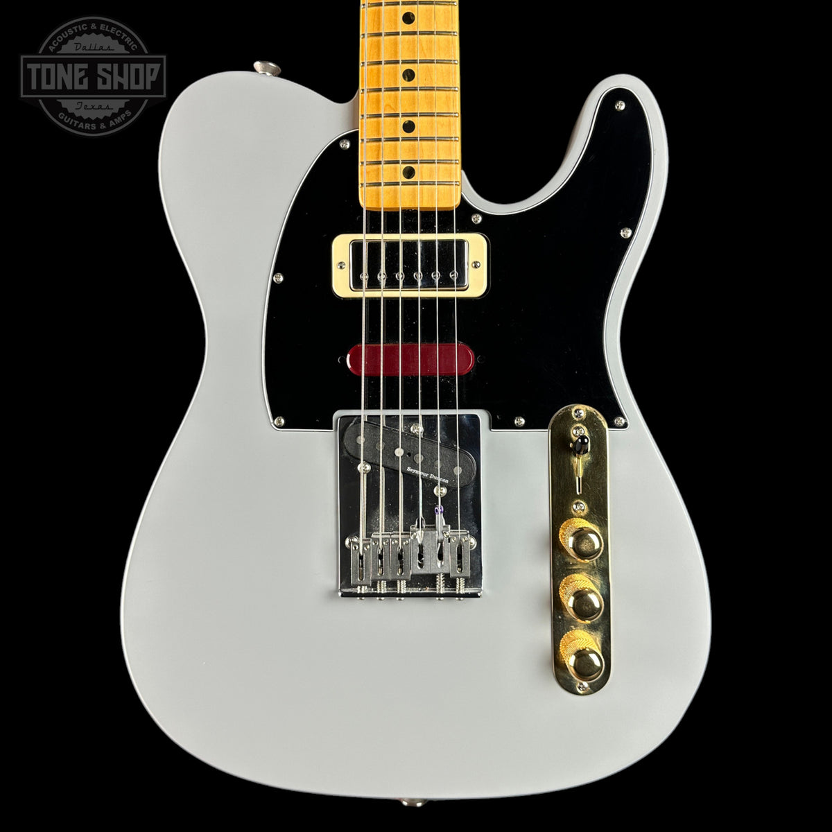 White electric guitar with a maple neck on a black background, featuring the Tone Shop logo.