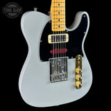 White electric guitar with a black pickguard on a black background, featuring the Tone Shop logo.