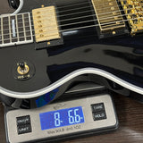 Black electric guitar on a digital scale displaying weight