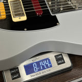 Guitar on a digital scale displaying weight