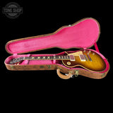 Gibson Les Paul guitar in a pink-lined case with 'Tone Shop' logo.