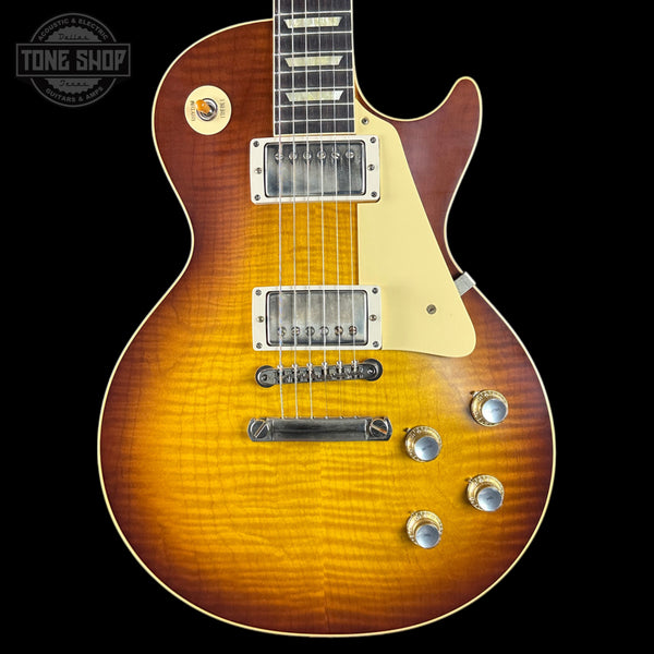 Electric guitar with a sunburst finish on a black background, featuring the Tone Shop logo.