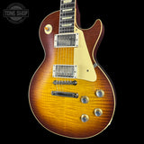 Electric guitar with a sunburst finish on a black background, featuring the Tone Shop logo.