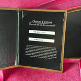 Gibson Custom Certificate of Authenticity on a pink background