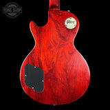 Red Gibson electric guitar on a black background with 'Tone Shop' logo.
