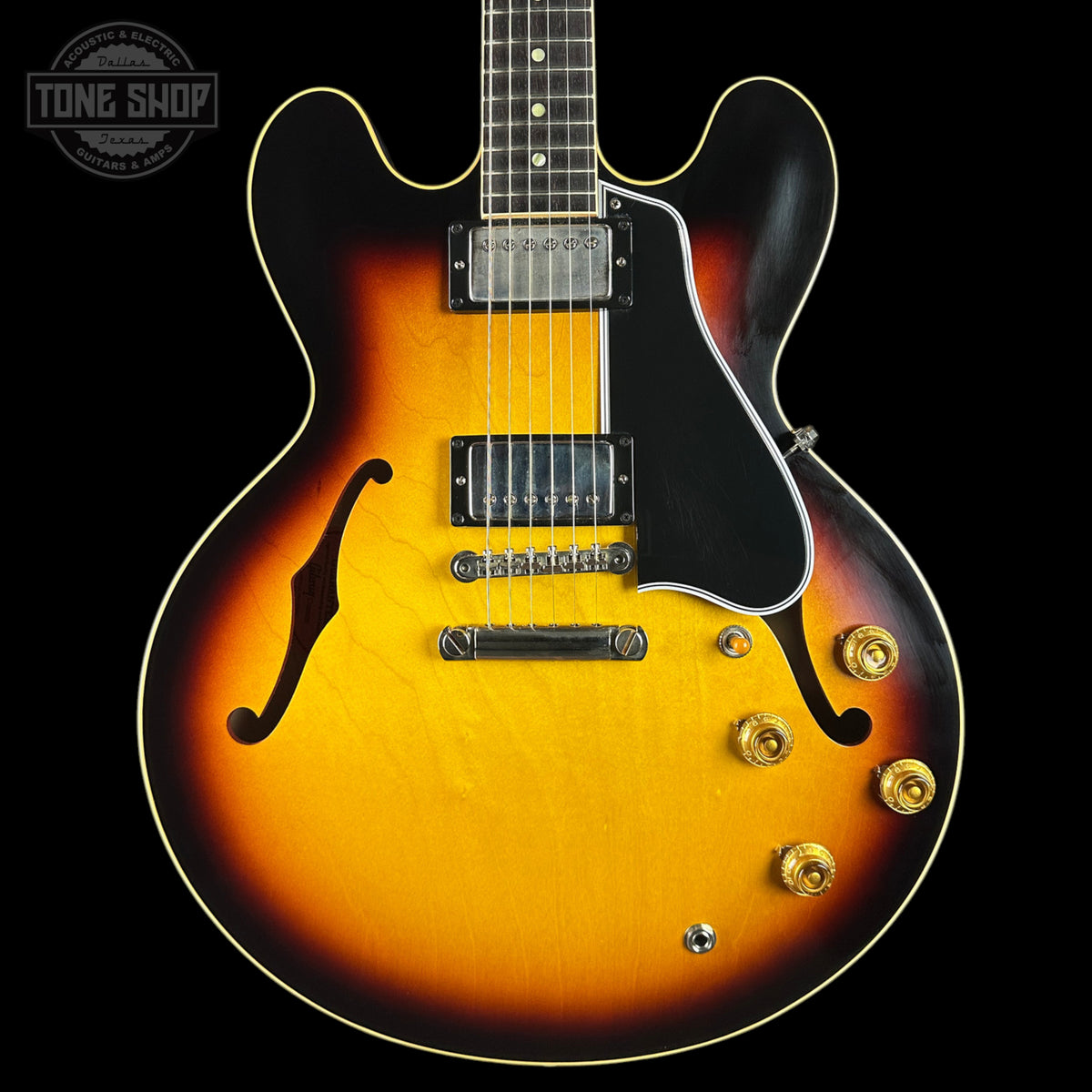 Electric guitar with a sunburst finish on a black background, featuring the Tone Shop logo.