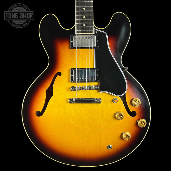 Electric guitar with a sunburst finish on a black background, featuring the Tone Shop logo.