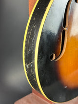 Close-up of a guitar's soundhole with a dark background