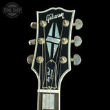 Gibson guitar headstock with brand logo on a black background