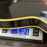 Digital scale displaying weight on a wooden surface