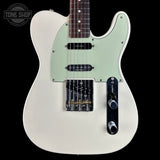 White electric guitar with a light green pickguard on a black background, featuring 'Tone Shop' branding.