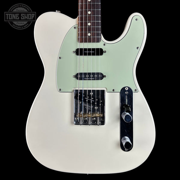 White electric guitar with a light green pickguard on a black background, featuring 'Tone Shop' branding.