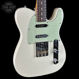 White electric guitar with a black pickguard on a black background, featuring the Tone Shop logo.