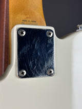 Close-up of a guitar's brand name plate with 'Made in Japan' text.