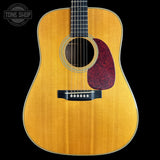 Acoustic guitar with a visible brand logo on a white background