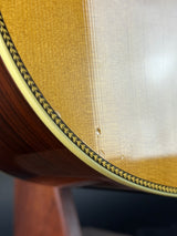 Close-up of a wooden chair with a woven seat