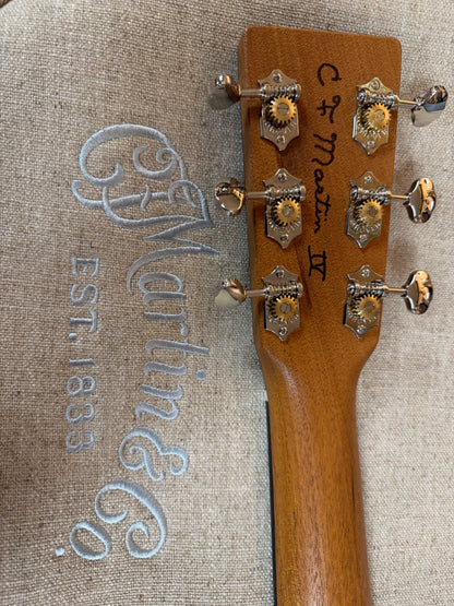 Close-up of a Martin guitar headstock with branding on a textured background