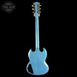 Blue electric guitar on a black background with 'Tone Shop' logo.