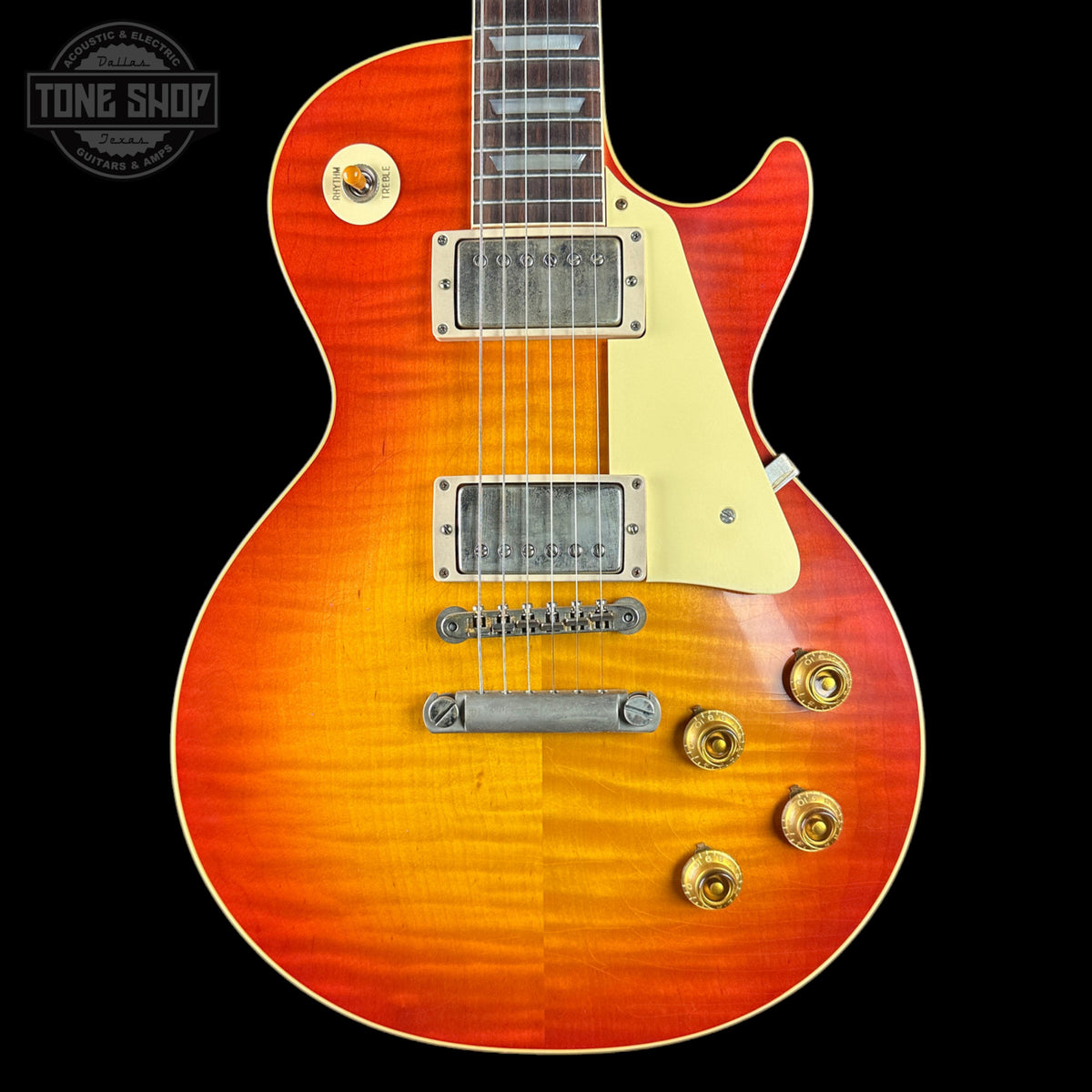 Electric guitar with a sunburst finish on a black background, featuring the Tone Shop logo.