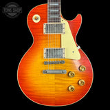 Electric guitar with a sunburst finish on a black background, featuring the Tone Shop logo.