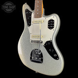 A silver glitter electric guitar with a white pickguard and black control plates, shown against a solid black background. A Tone Shop watermark is visible in the top left corner.