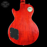 Red Gibson electric guitar body on a black background with 'Tone Shop' logo.