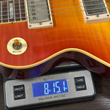 Electric guitar on a digital scale displaying weight