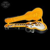 Electric guitar in an open case with a visible 'Tone Shop' logo.