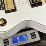 Digital scale displaying weight of a white electric guitar