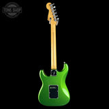 Green electric guitar with a black background