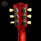 Close-up of a red guitar headstock with tuning pegs on a black background, featuring 'Tone Shop' branding.