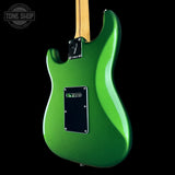 Green electric guitar with a black pickguard on a black background, featuring 'Tone Shop' logo.