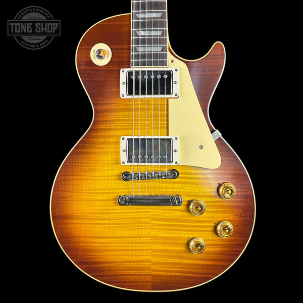 Electric guitar with a sunburst finish on a black background, featuring the Tone Shop logo.