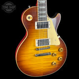 Electric guitar with a sunburst finish on a black background, featuring the Tone Shop logo.