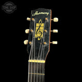 Guitar headstock with 'Harmony' logo on a black background