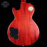 Red electric guitar body with a visible brand logo on a black background