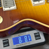 Guitar on a digital scale displaying weight